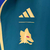 Agasalho corta vento Roma Dupla Face da Adidas, nas cores verde e azul, com detalhes em amarelo e logo da marca.