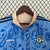 Agasalho corta vento Adidas Manchester United com estampa floral em azul e bege, modelo 2024/25.