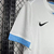 Camisa branca do Uruguai II 2024/25, modelo torcedor masculino da Nike, com detalhes em azul e número 15.