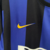 Camisa retrô da Inter de Milão, modelo masculino de 1999/2000, nas cores azul e preta, com detalhes em amarelo e logotipo da Nike.

