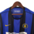 Camisa retrô da Inter de Milão, modelo masculino de 1999/2000, nas cores azul e preta, com detalhes em amarelo e logotipo da Nike.

