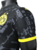 Camisa preta do Borussia Dortmund II 23/24, modelo masculino, com detalhes em amarelo e logo da Puma.

