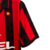 Camiseta retrô do AC Milan da temporada 1988/89, nas cores vermelha e preta, com logo da Lotto e estampa da Opel.

