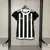 Camisa feminina do Atlético Mineiro, modelo 24/25, com listras verticais em preto e branco e logo do clube.