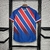 Camisa do Bahia Away 24/25 Torcedor Masculina nas cores vermelho e azul, com detalhes em listras diagonais e logotipo do clube.

