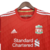 Camisa retrô masculina do Liverpool, temporada 2010/2011, na cor vermelha com detalhes em branco e logotipo da Adidas.

