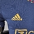 Camisa azul do Ajax Away 22/23, modelo masculino, com detalhes em dourado e logo da Adidas.

