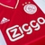 Camisa Ajax Home 22/23 Adidas Masculina, predominantemente branca com detalhes em vermelho e logo do Ajax.

