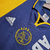 Camisa retrô do Ajax, temporada 2000/2001, nas cores azul e amarela, com logo da Adidas e patrocínio ABN AMRO.

