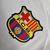 Camisa branca do Barcelona para torcedores, com mangas longas e logotipo da Nike e Spotify.

