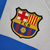 Camisa branca do Barcelona III 22/23, com detalhes em azul e vermelho, logo da Nike e patrocínio da Spotify

