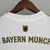 Camisa branca do Bayern de Munique, modelo Away 22/23, com detalhes em dourado e logotipo da Adidas.

