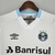 Camisa branca do Grêmio II 22/23, modelo torcedor masculino, com logotipo da Umbro e patrocinador Banrisul

