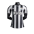 Camisa masculina do Newcastle United, modelo Home 23/24, nas cores preto e branco, com detalhes em relevo e logo do time.