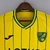 Camisa amarela do Norwich City, temporada 22/23, com detalhes em verde e logotipo da equipe.

