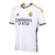 Camisa branca do Real Madrid I 23/24, modelo torcedor Adidas masculino, com detalhes em dourado e logo do clube.