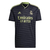 Camisa preta do Real Madrid, modelo 22/23, com detalhes em verde e logo da Adidas.