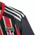 Camisa de futebol masculina do São Paulo II 23/24, nas cores vermelho e preto, com listras verticais e detalhes em branco.