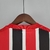 Camisa torcedor do São Paulo II 22/23, com listras vermelhas, pretas e brancas, confeccionada pela Adidas.