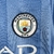 Camisa feminina do Manchester City, azul com detalhes em branco, fabricada pela Puma, temporada 2023/2024.

