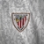 Camisa branca do Athletic Bilbao III 23/24, com detalhes em vermelho e preto, da marca Castore, exibindo o logo do clube e o patrocínio da Kutxabank.

