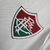 Camisa masculina branca do Fluminense II 24/25, com detalhes em verde e vermelho, logo da Umbro e escudo do time.