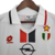 Camisa retrô branca do AC Milan II, modelo 1995/1997, com detalhes em vermelho e preto, logotipo da Opel e emblemas da equipe.

