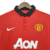 Camisa retrô vermelha do Manchester United da temporada 2013/2014, fabricada pela Nike, com detalhes em preto e logo do time.

