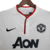 Camisa retrô branca do Manchester United da temporada 2013/2014, fabricada pela Nike, com logo da equipe e patrocinador em destaque.

