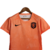 Camisa feminina laranja da Seleção da Holanda, modelo 23/24, da Nike, com logo da marca e escudo da seleção.

