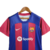 Camisa feminina do Barcelona I 23/24 da Nike, nas cores azul e grená, com logo da equipe e da Spotify.

