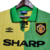 Camisa retrô do Manchester United, modelo 1992/1994, nas cores verde e amarela, com o logo da Umbro e o patrocínio da Sharp.

