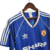 Camisa retrô azul do Manchester United da temporada 1988/1990, com detalhes em branco e logo da Adidas.

