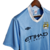 Camisa retrô azul do Manchester City, temporada 2011/2012, fabricada pela Umbro, com logo do clube e patrocinador ETIHAD.

