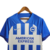 Camisa do Brighton & Hove Albion na cor azul e branca, com listras verticais e o logo da Nike.

