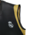 Camisa regata preta do Real Madrid, modelo torcedor Adidas, temporada 23/24, com detalhes em amarelo.

