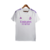 Camisa branca do goleiro do Real Madrid 23/24 com detalhes em roxo e logo da Adidas.