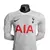 Camisa branca de manga longa do Tottenham, modelo 23/24, com logo da Nike e estampa "AIA" em vermelho.

