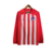 Camisa longa do Atlético de Madrid, vermelha e branca, com listras verticais e logo da Nike.