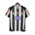 Camisa retrô da Juventus 2002/2003, preta e branca, com listras verticais, logotipo Lotto e patrocinador Tamoil.
