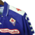 Camisa retrô roxa da Fiorentina de 1998, com detalhes em branco e logo da Fila e Nintendo.

