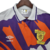 Camisa retrô branca da seleção da Escócia, com detalhes em laranja e roxo, fabricada pela Umbro.

