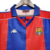 Camisa retrô do Barcelona de 1992/1995 nas cores azul e vermelha, com detalhes da marca Kappa.

