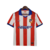 Camisa retrô do Atlético de Madrid da temporada 2014/2015, nas cores branca e vermelha, com detalhes em azul.