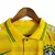 Camisa polo amarela da seleção brasileira, com detalhes em verde e patrocínios visíveis.

