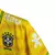 Camisa polo amarela da seleção brasileira, com detalhes em verde e patrocínios visíveis.

