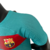 Camisa Barcelona III 23/24 masculina da Nike, na cor verde com detalhes em azul e vermelho, exibindo o logo do clube e da Spotify.

