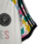 Camisa branca do Inter Miami, modelo de treino 23/24, com detalhes coloridos nas mangas e a frase 'LOVE UNITES' estampada na frente.

