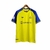 Camisa amarela do Al-Nassr I 23/24 para torcedores, com detalhes em azul e logotipo do time.