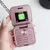 Celular pequeno dobrável na cor rosa com tela e teclas visíveis, exibindo a opção de 'Call center'.